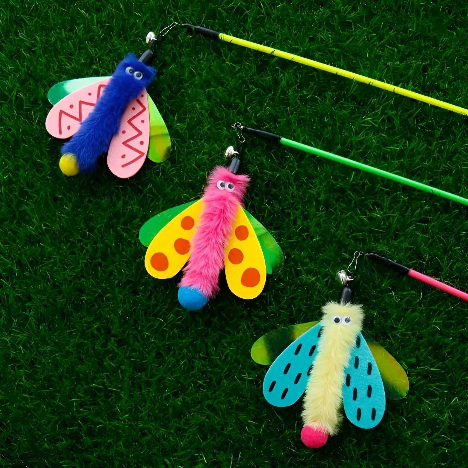 Cat wand toy with bell and dragonfly attachment in green, ABS stick 49cm long, on a light background