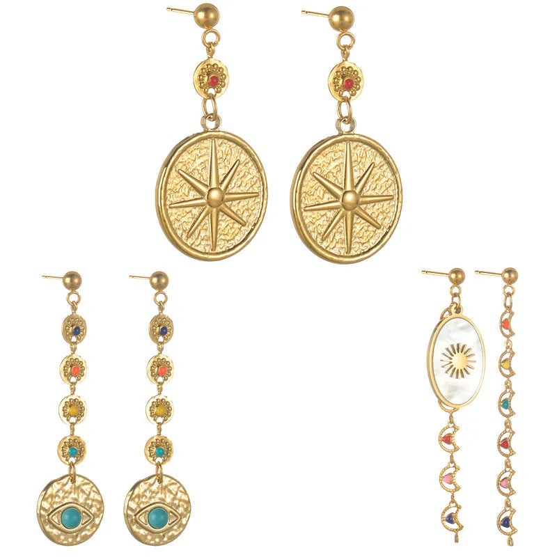 Three pairs of geometric stainless steel earrings: eight-point star, eye motif and shell sun designs