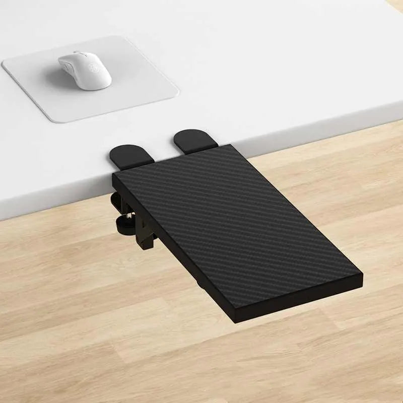 Ergonomic hand bracket in black carbon fiber veneer on a desk for arm support during computer use