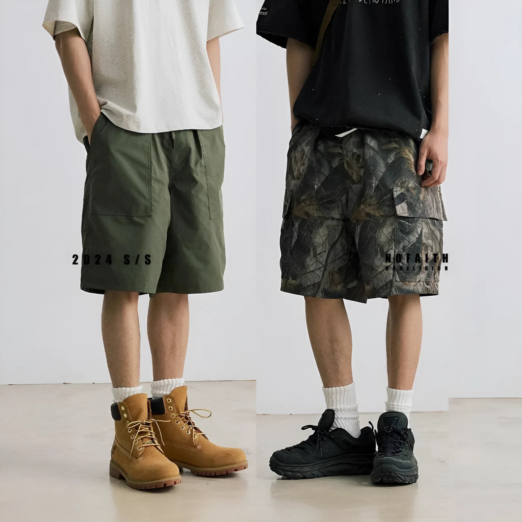 Men's loose fit straight-leg denim shorts in army green on a plain background.