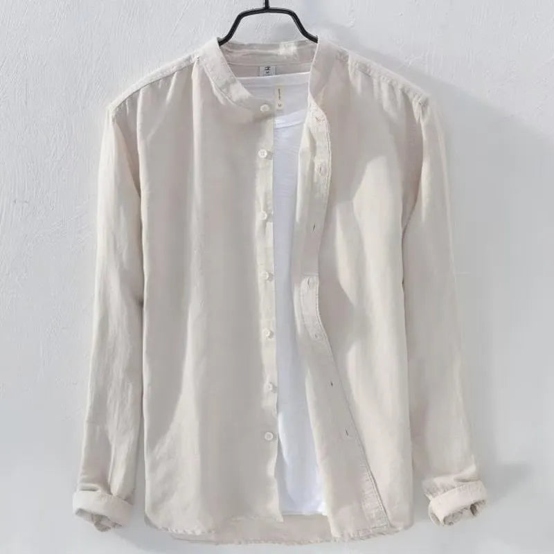 Man wearing a loose-fit light blue linen blend long sleeve casual shirt.