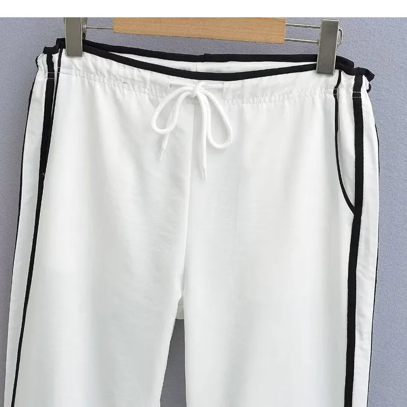 Navy blue loose straight-leg trousers with contrast detail, shown on a hanger.