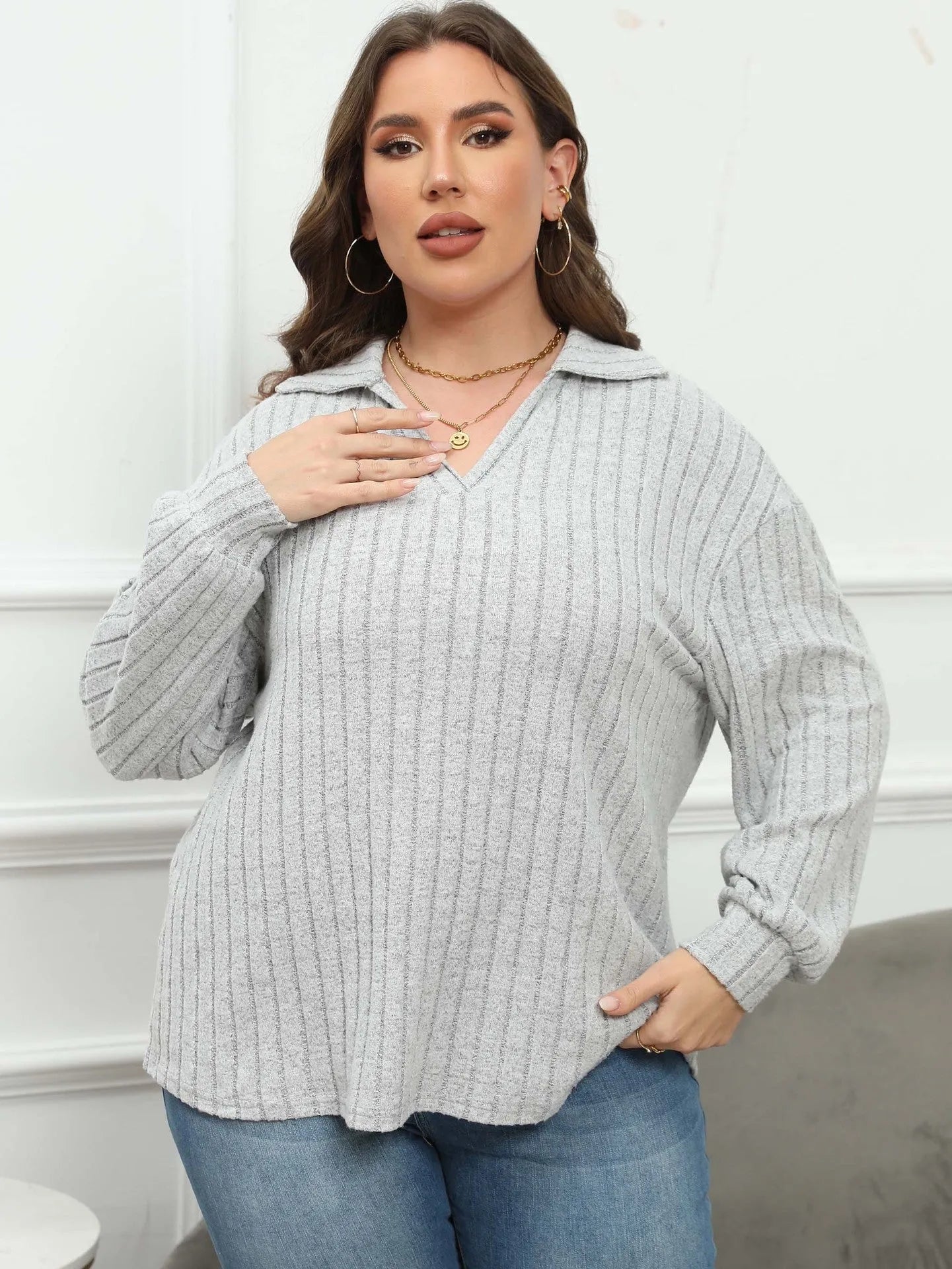 Plus size women's gray fleece pullover with a polo collar and lantern sleeves on a hanger.