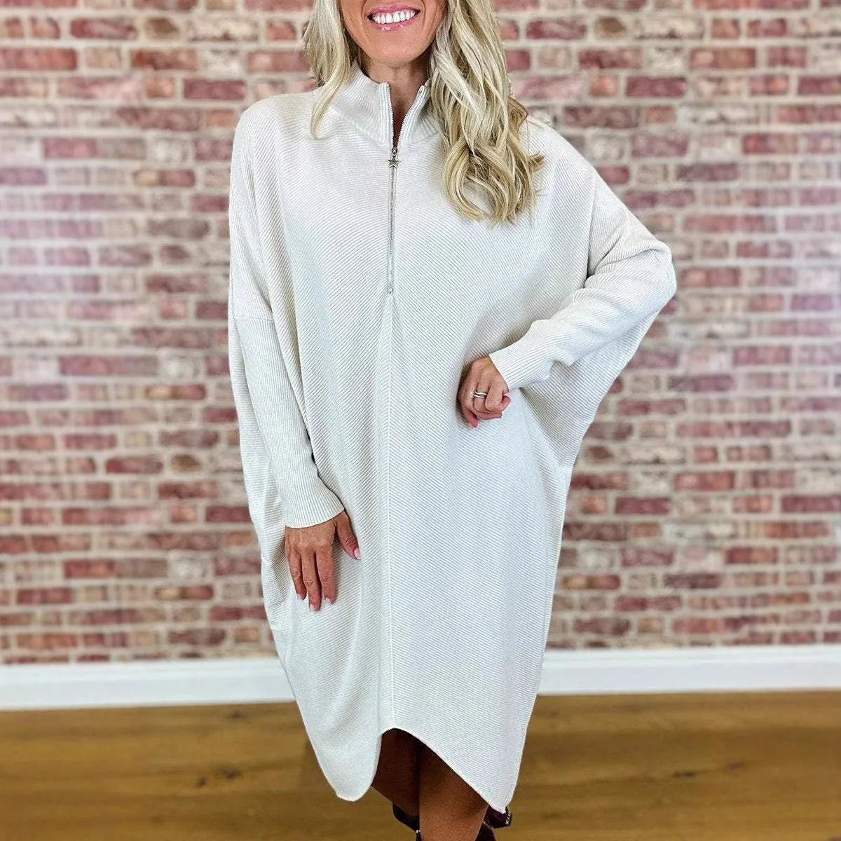 Women's solid colour knitted loose dress with raglan sleeves and a front zip.