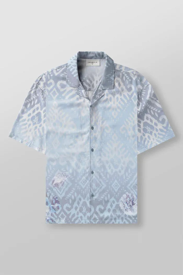 Man wearing a loose, light grey printed short sleeve casual top made from stretch polyester fabric.