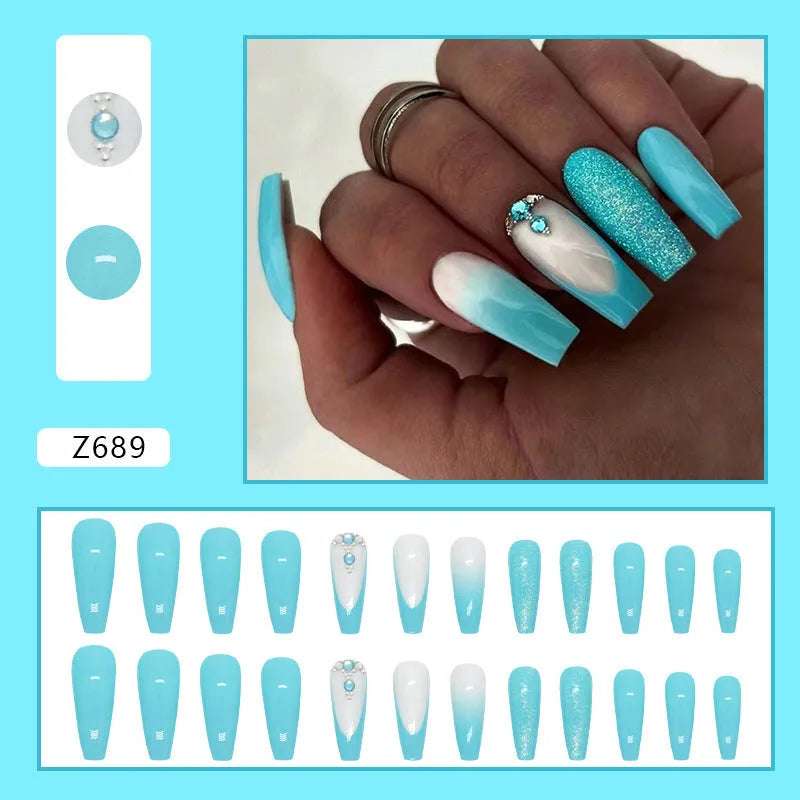 Long ballet-shaped false nails with solid blue colour and smart diamond glitter, shown with glue.