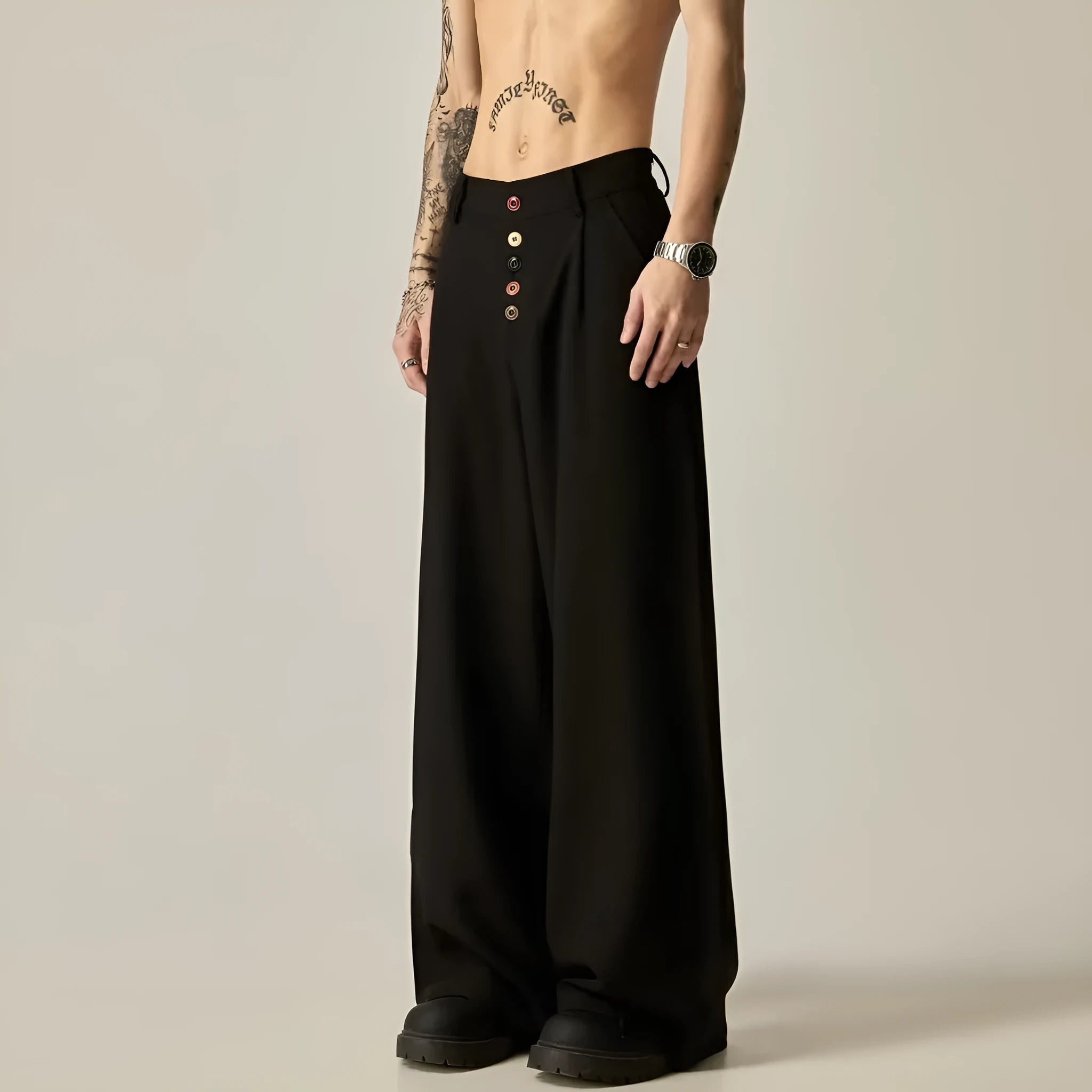 Men's solid black casual straight-leg trousers with a wide-leg fit and button fly on a neutral background.