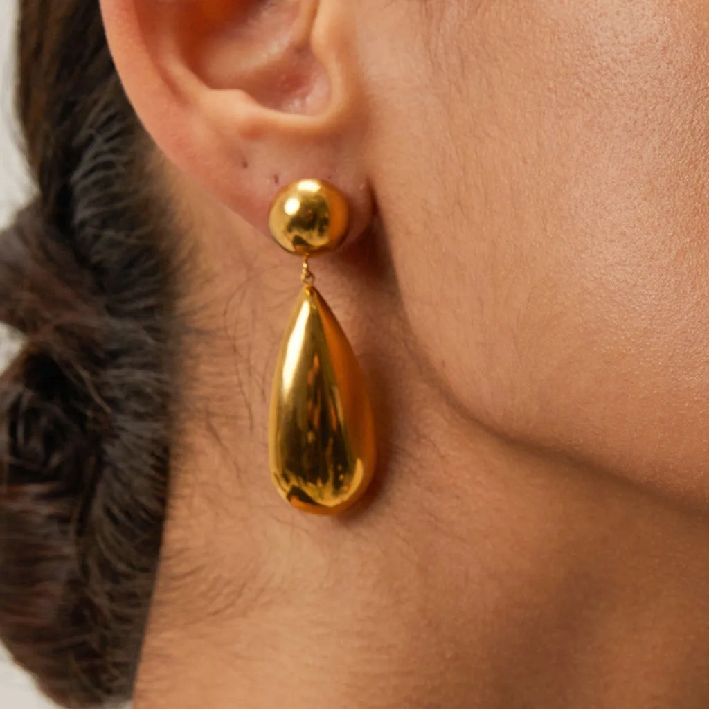 Gold-coloured stainless steel water drop pendant earrings with geometric hemisphere design