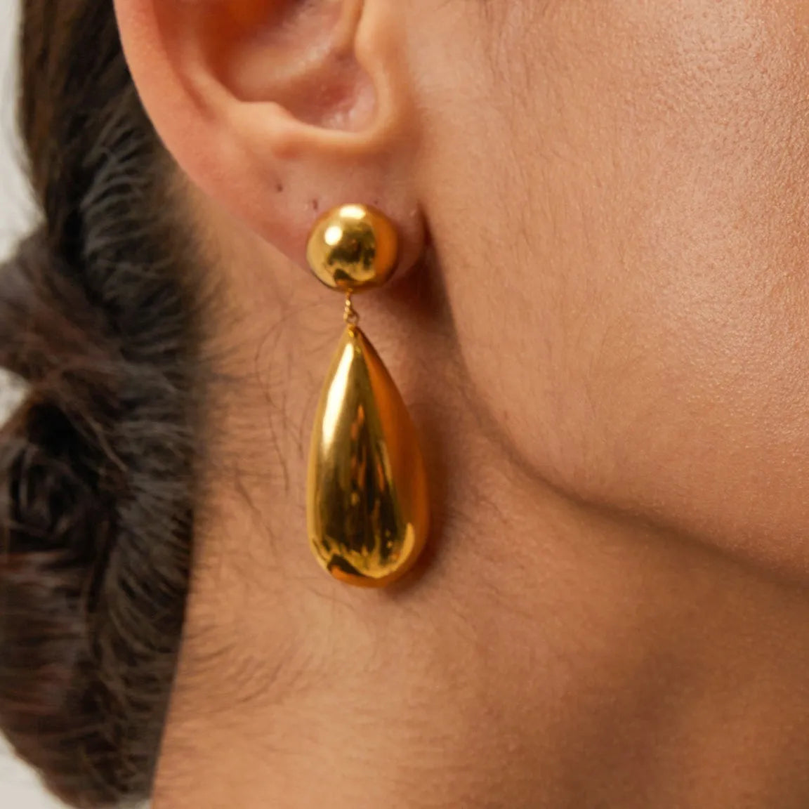 Gold-coloured stainless steel water drop pendant earrings with geometric hemisphere design