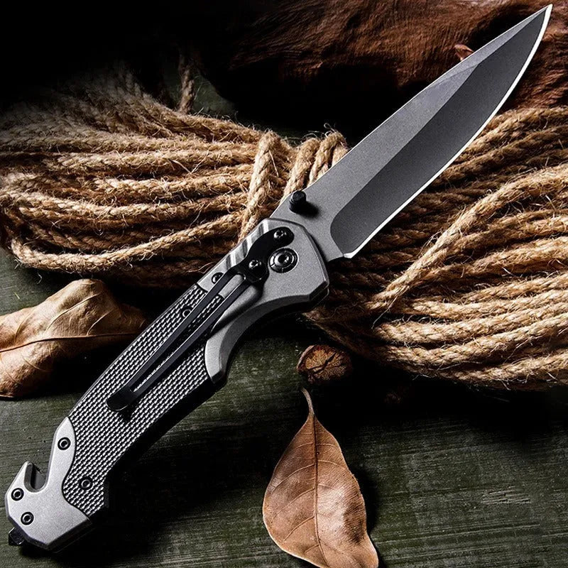 Portable folding knife with alloy blade, 225mm full length, on outdoor surface