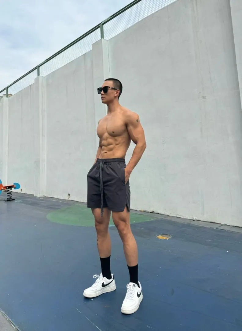 Men's ice silk quick-drying double-layer casual shorts in quarter length style.