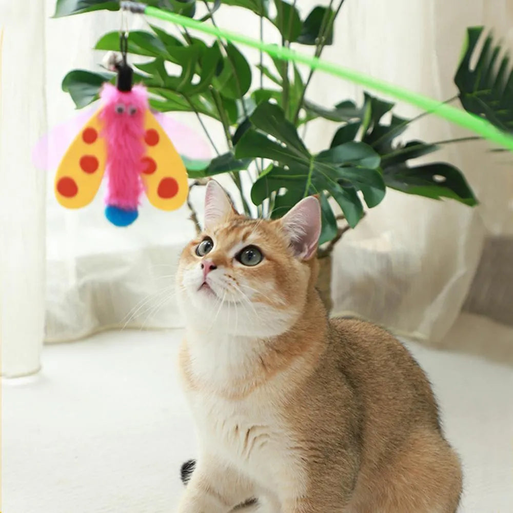 Cat wand toy with bell and dragonfly attachment in green, ABS stick 49cm long, on a light background