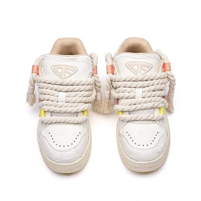 Old Damage brand creamy white retro skate shoes with low platform heel and lace-up front.
