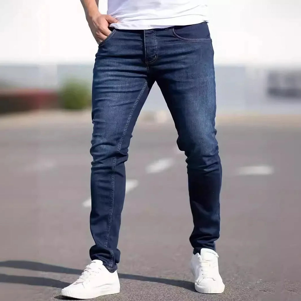 Dark blue men's slim fit cotton jeans with a skinny leg opening on a mannequin