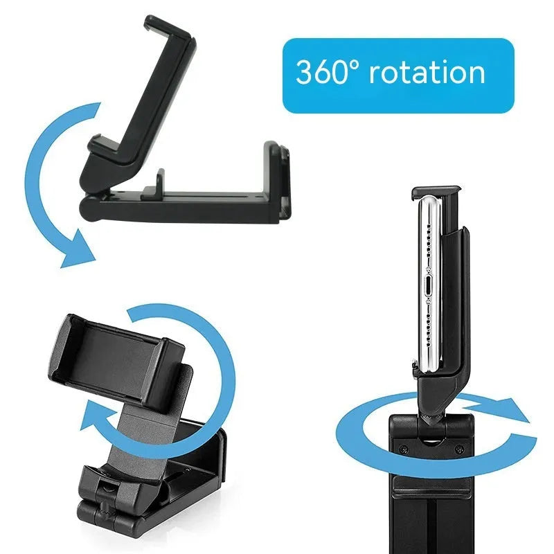 360 rotary collapsible mobile phone holder in black on a desk, with a phone propped up in landscape mode
