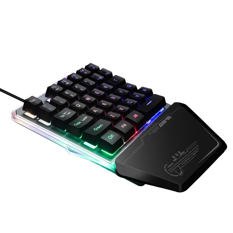 Black robotic one-handed mechanical keyboard with RGB backlighting on a desk