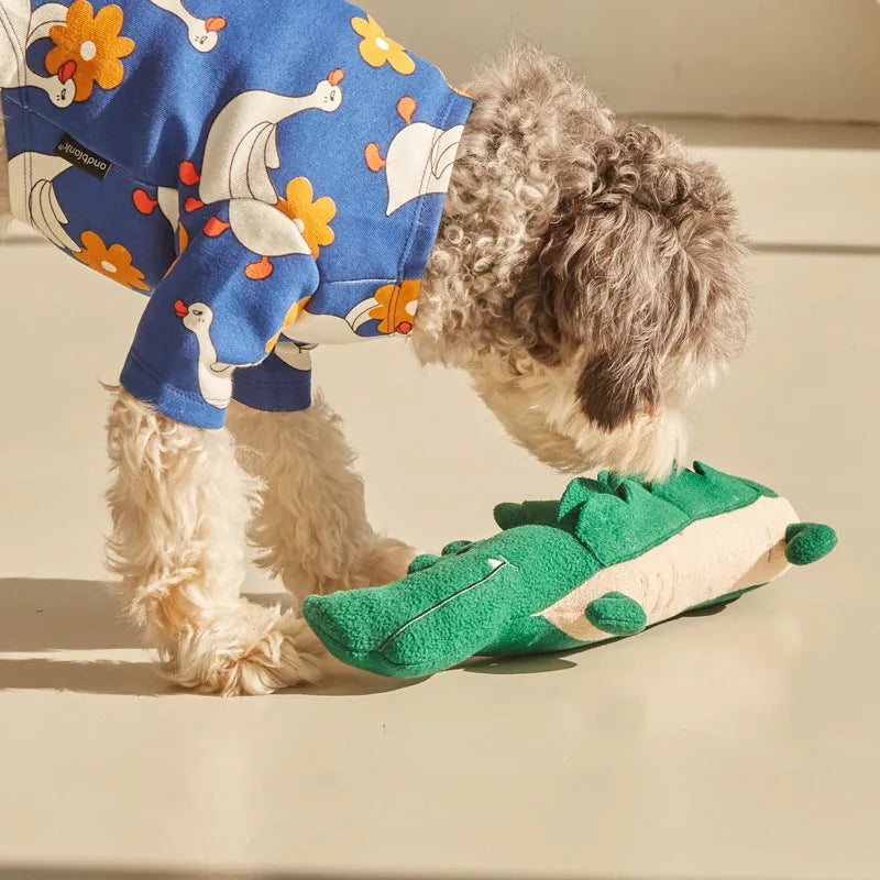 Green plush toy dog soft stuffed animal on white background.