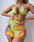 Women's yellow halter lace-up striped swimsuit set with top, skirt, and shorts on a model