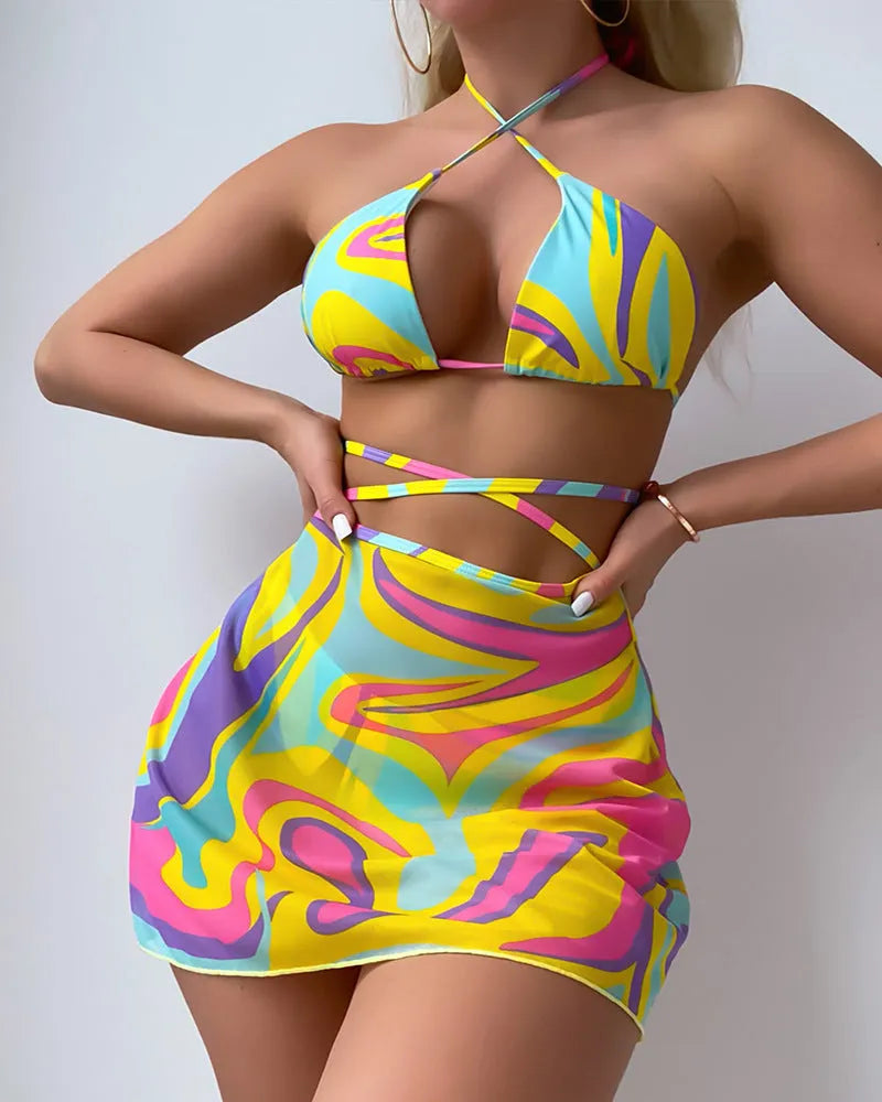 Women's yellow halter lace-up striped swimsuit set with top, skirt, and shorts on a model