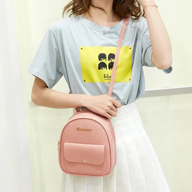 Women's small PU shoulder backpack 18.5cm length in black, blue, grey, pink, or red with zipper closure