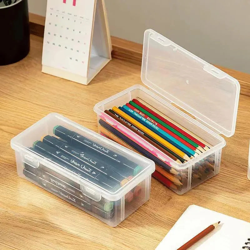 Transparent plastic stationery storage box showing pencils and art supplies inside