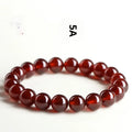 Natural orange red garnet ball bracelet with ruyi element in retro unisex design on wrist