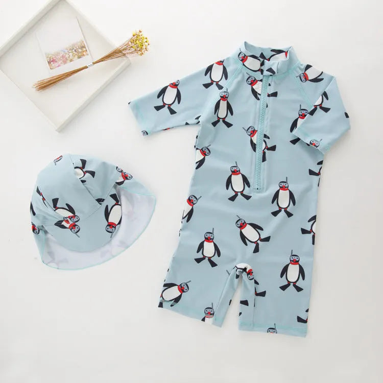 Boys' long-sleeve penguin print swimsuit set with matching swimming cap on mannequin