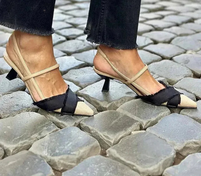 Apricot and black women's stiletto sandals with a buckle strap and pointed toe.