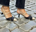 Apricot and black women's stiletto sandals with a buckle strap and pointed toe.