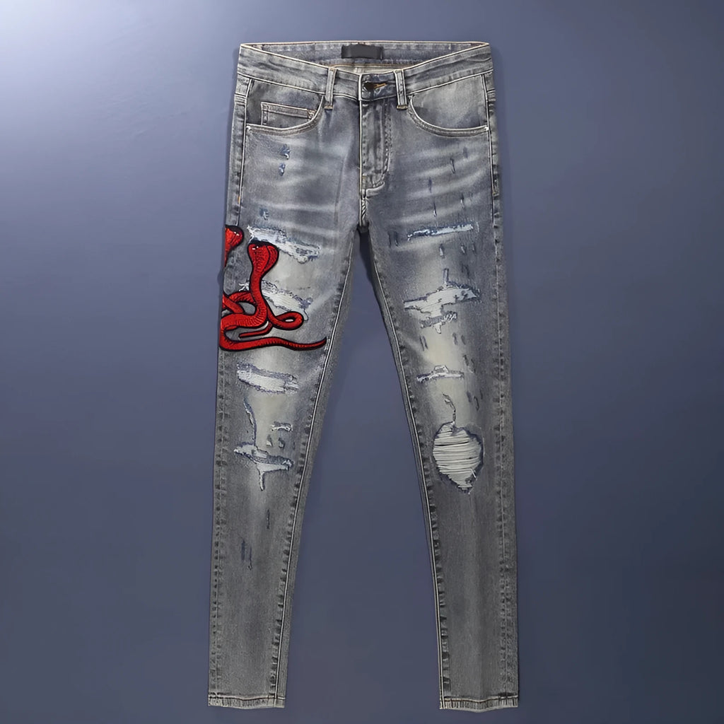 Washed-out old colour slim fit jeans with distressed patches and embroidery detail