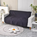 Soft reversible dog blanket couch cover in burgundy with grey reverse side, laid flat on sofa