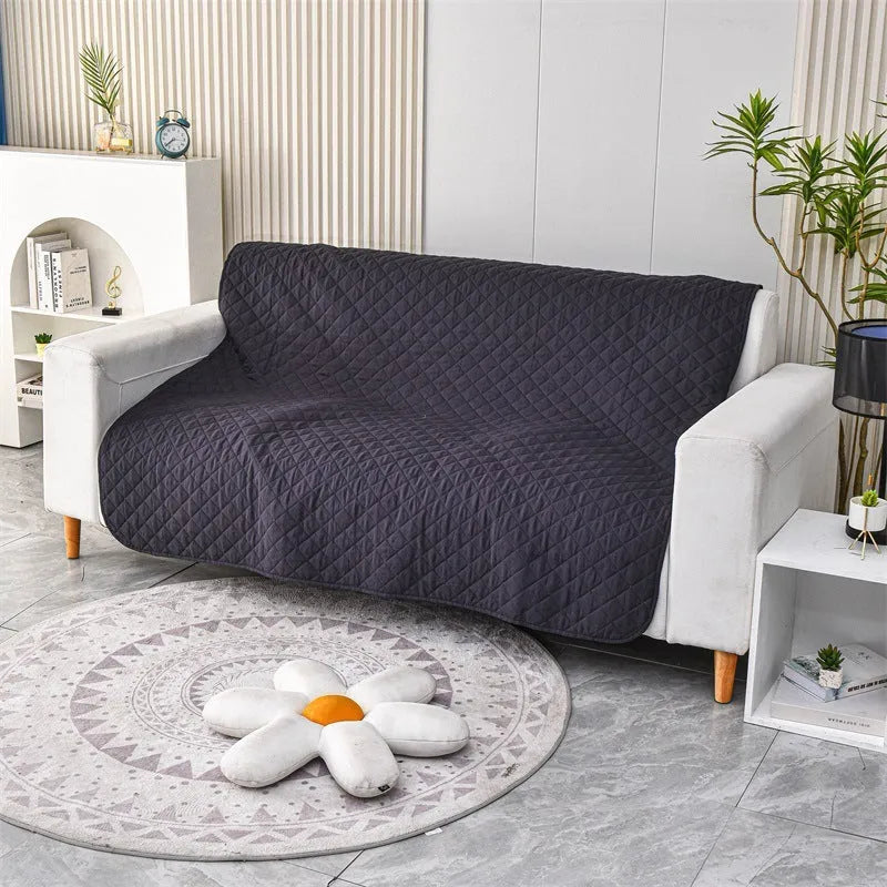 Soft reversible dog blanket couch cover in burgundy with grey reverse side, laid flat on sofa