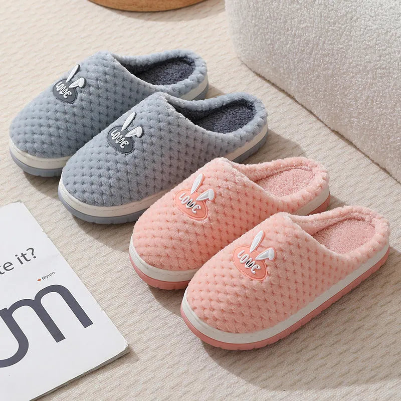 Women's rabbit plaid design artificial fur house slippers with a thick non-slip rubber sole.