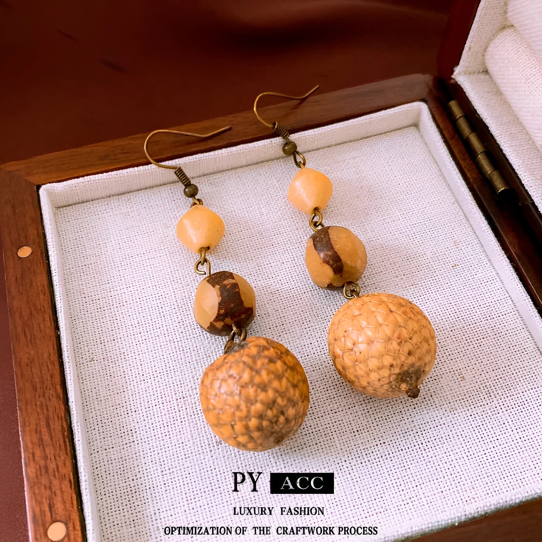 Retro ethnic style brown resin fruit core tassel earrings with geometric round design for women.