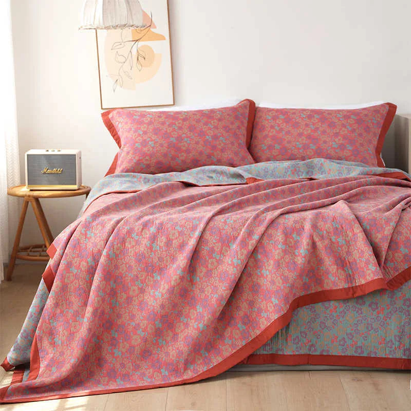 Cotton gauze three-piece bedding set with botanical flower pattern showing blanket and two matching pillowcases