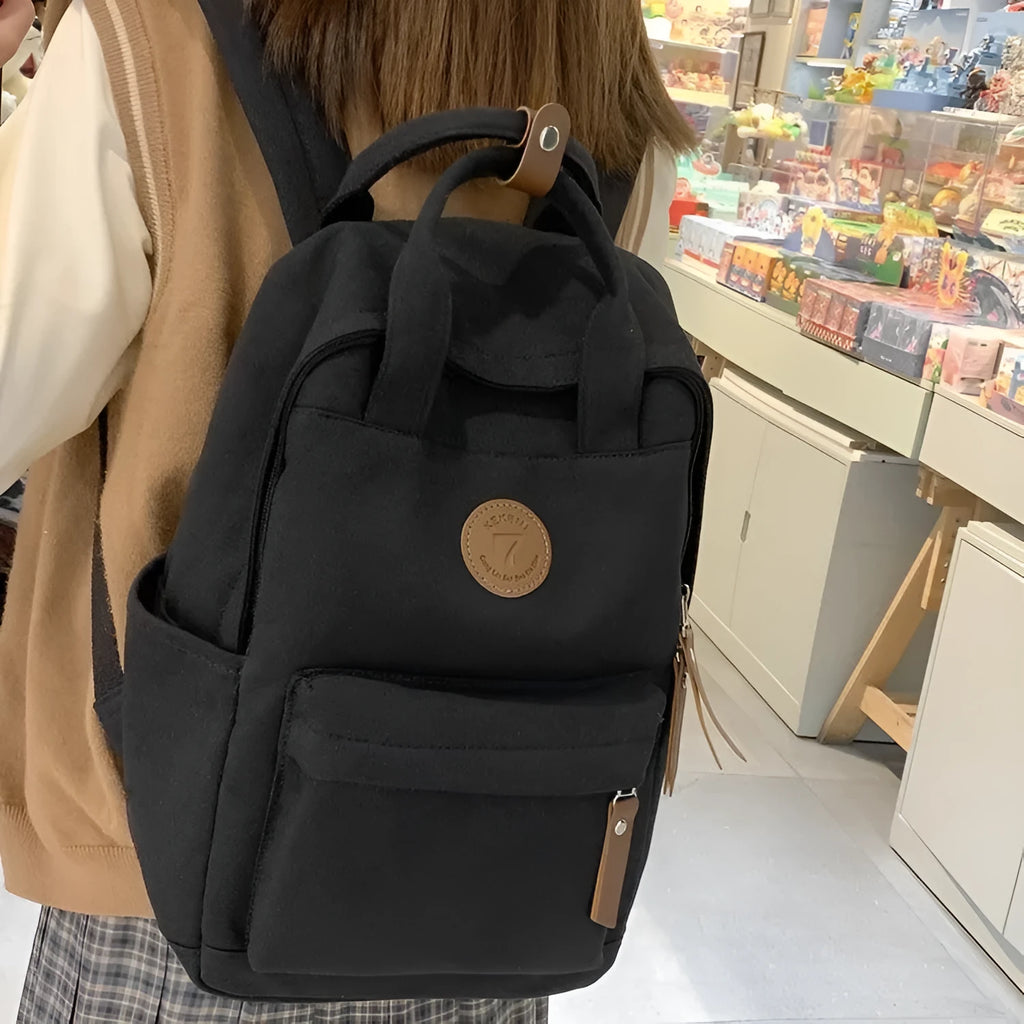 Black fashion backpack made of Oxford cloth with curved shoulder strap and retro stitching for school and travel