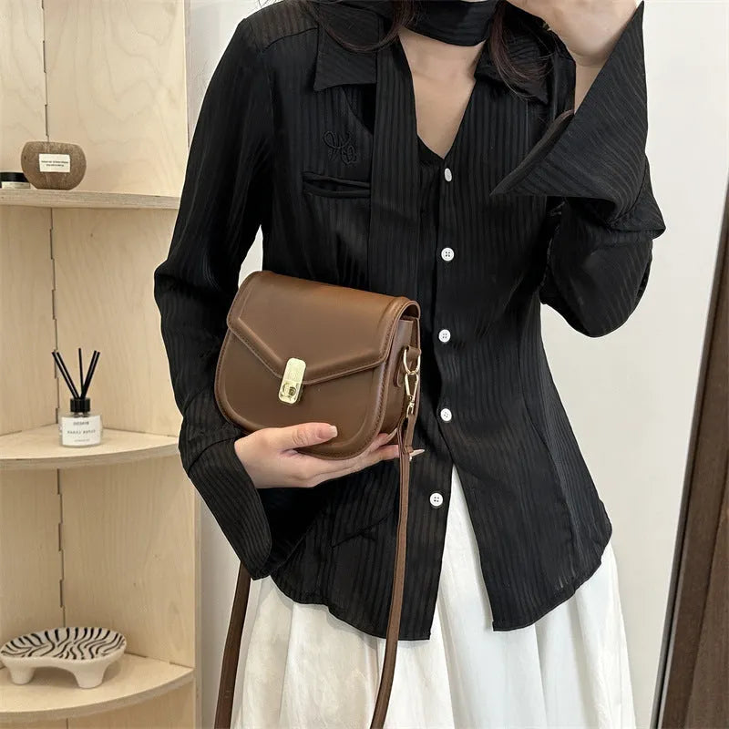 Soft PU leather clamshell shoulder messenger bag in horizontal square shape.