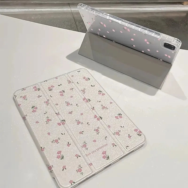 Transparent floral tri-fold hard case for iPad showing magnetic closure and stylus loop.