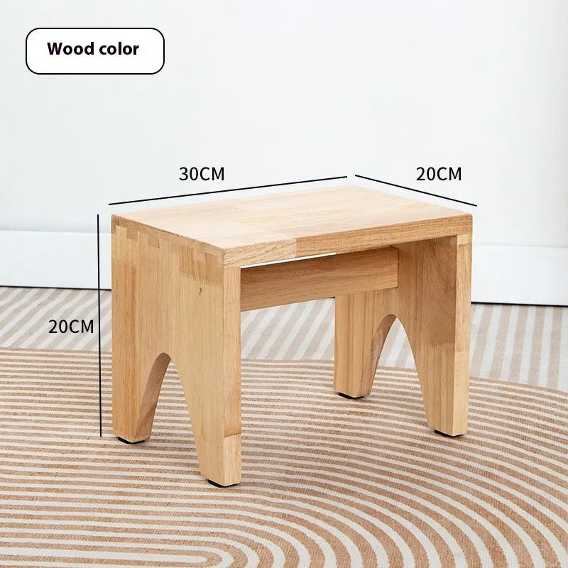 Distressed wooden stool with bracket structure legs in rustic finish