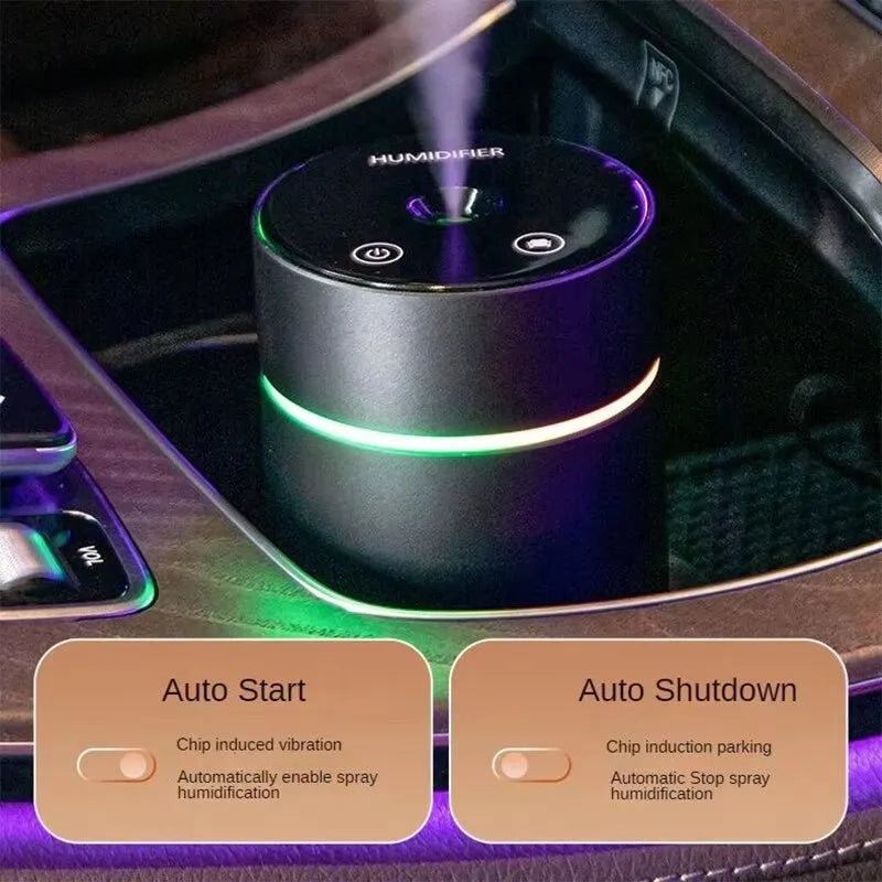 Black A6 aluminium alloy portable car humidifier and essential oil diffuser with USB cable on a desk.