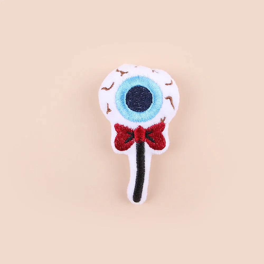 Plush cat teaser wand toy with colourful candy and skull designs on small attachment