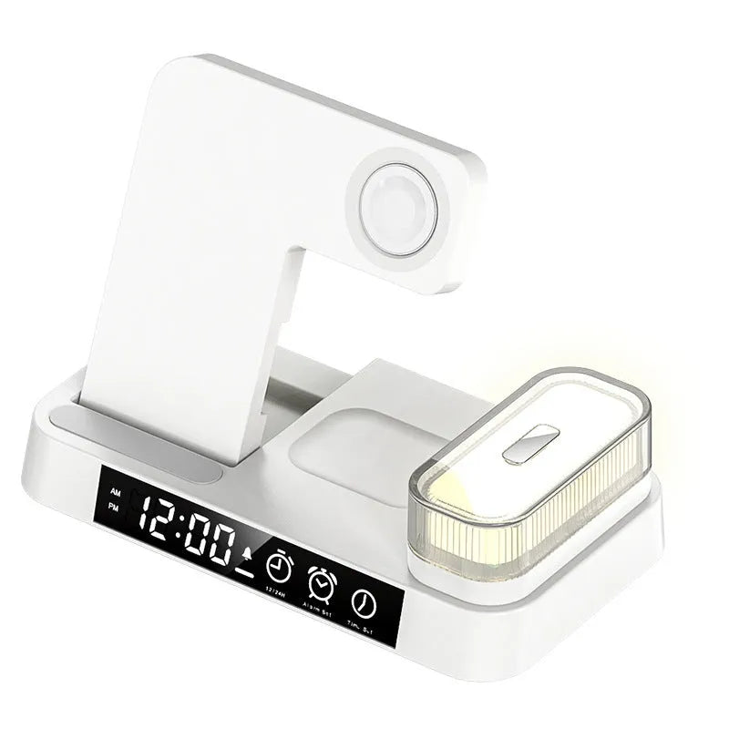 4-in-1 wireless charger station with alarm clock display and foldable stand charging a phone, headphones and watch