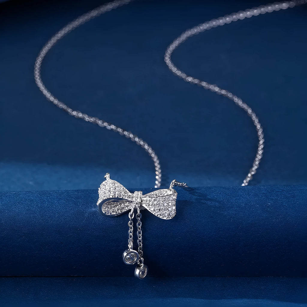925 sterling silver necklace with a bow pendant on a silver O-ring chain.