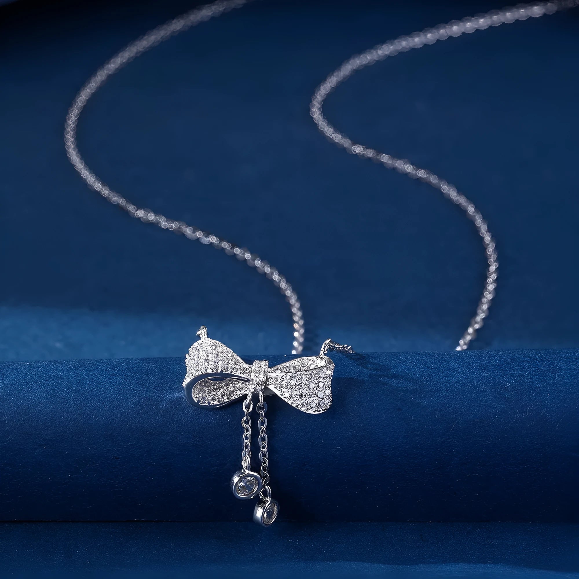 925 sterling silver necklace with a bow pendant on a silver O-ring chain.
