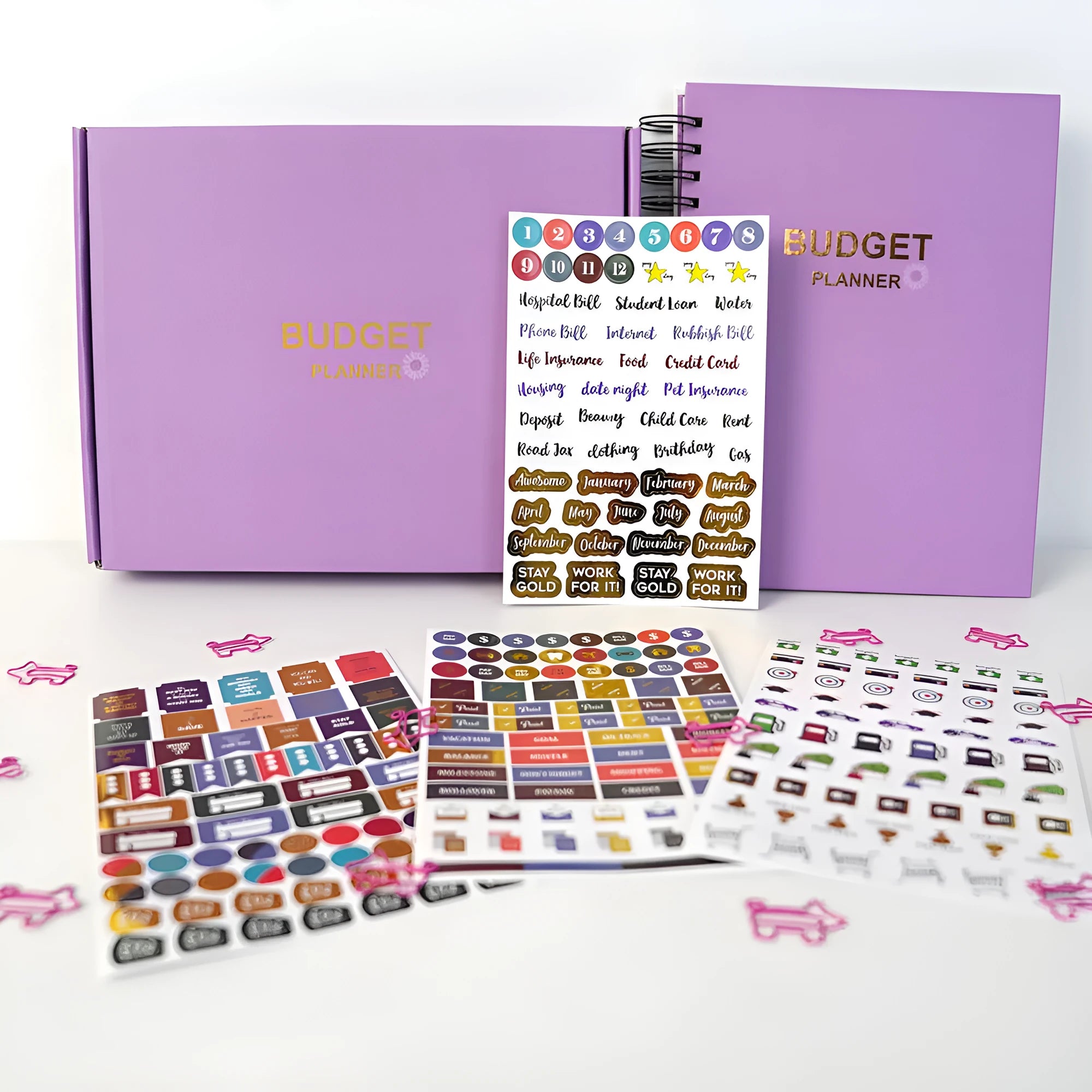 J12 purple coil-bound budget notebook with stickers and paper clips for financial planning