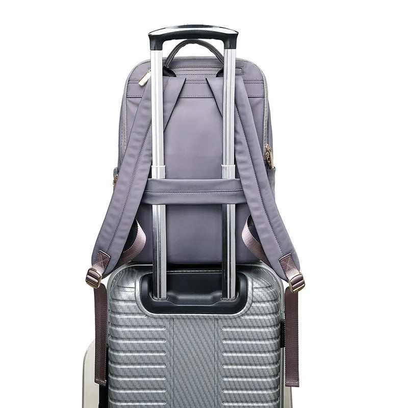 Large black and purplish grey Oxford cloth women's backpack showing anti-theft compartments and breathable back.