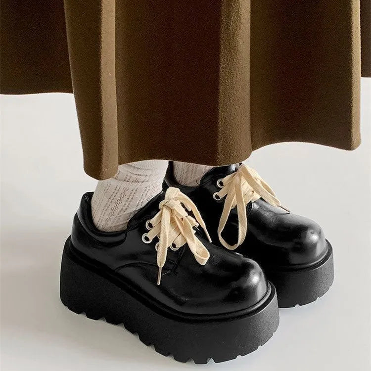 Women's matte black chunky heel lace-up shoes with a round toe and thick rubber sole.
