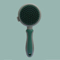 Pink and green dual-sided cat grooming brush with flea comb and release button