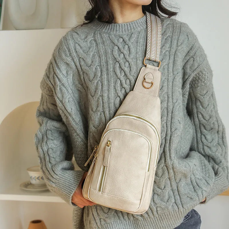 Soft PU women's crossbody bag in brown colour with open outer pocket and adjustable strap