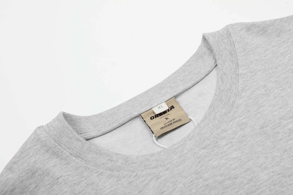 Man wearing a loose-fit grey cotton long sleeve pullover in American retro style